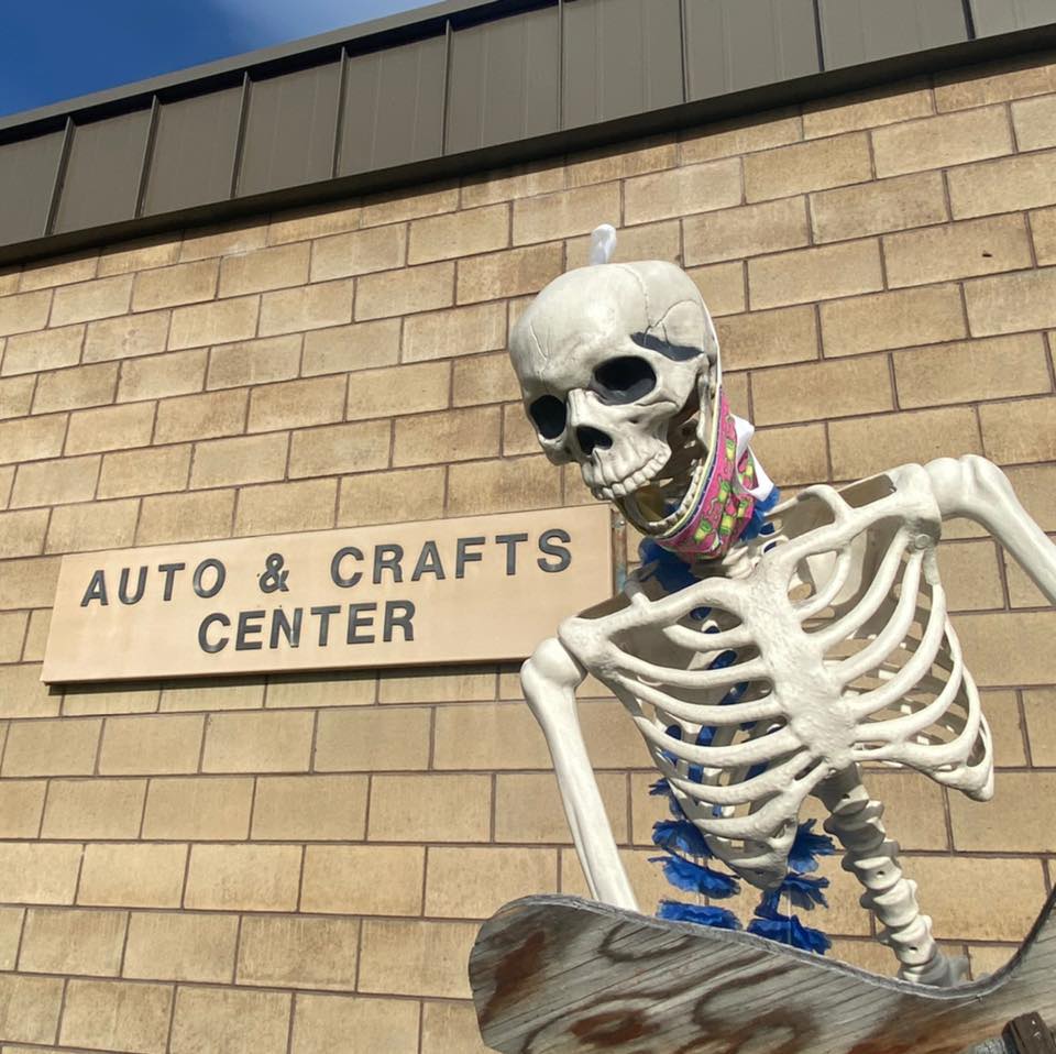 halloween skeleton in front of arts and crafts center sign