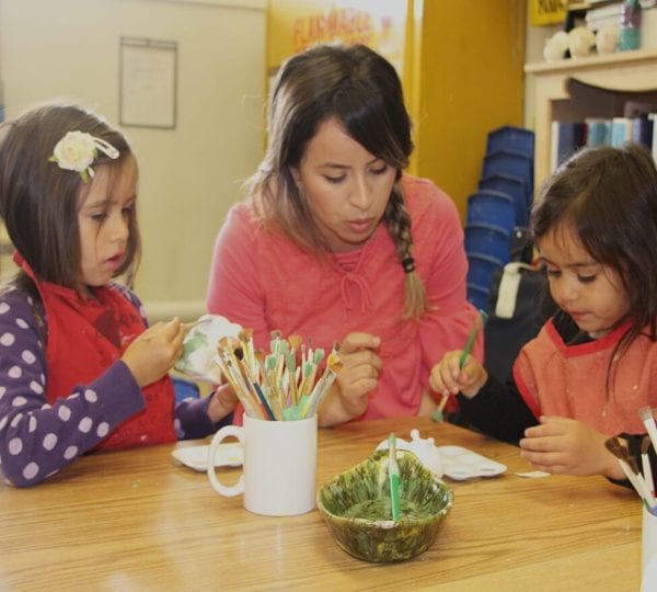 family painting objects at table