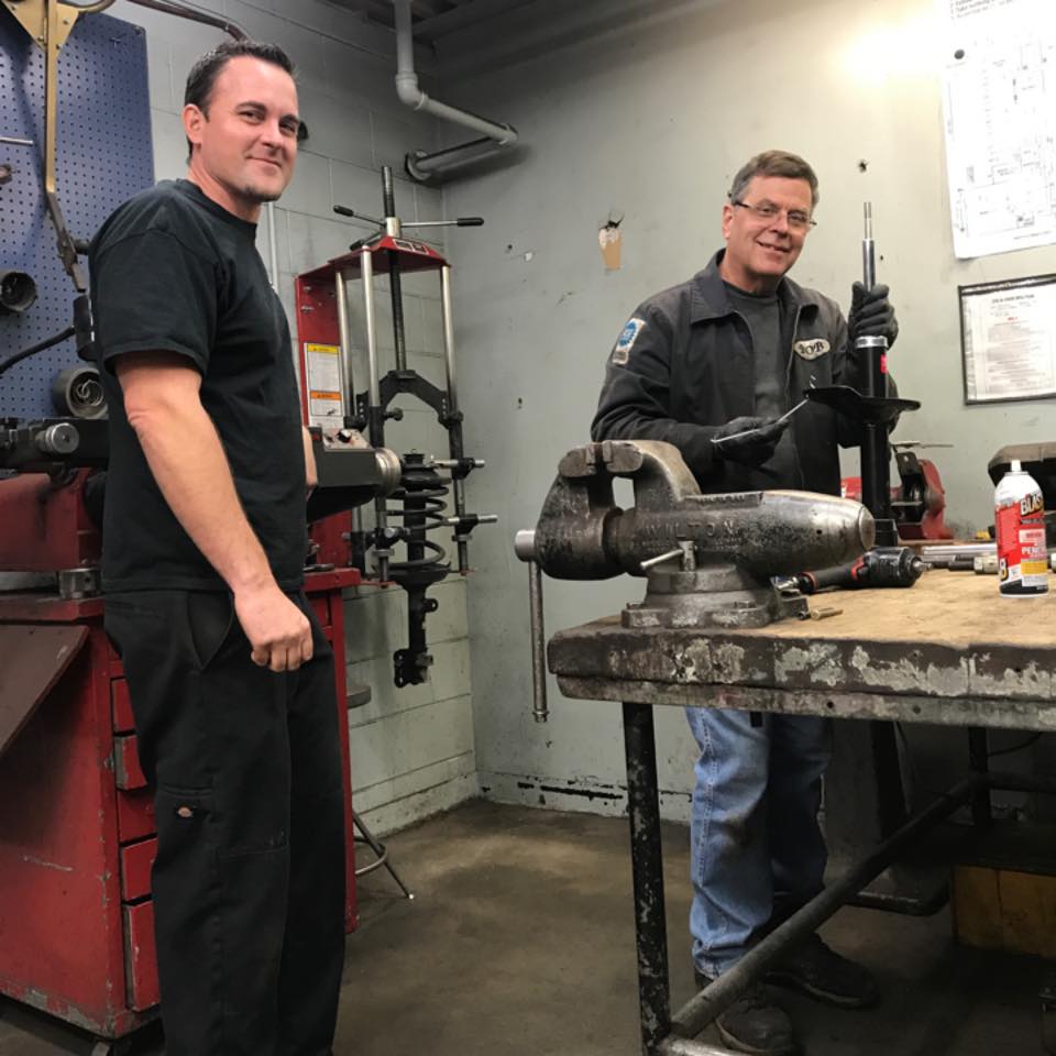 two happy men working on a repair