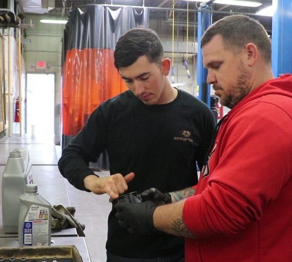 two men hard at work on repairs