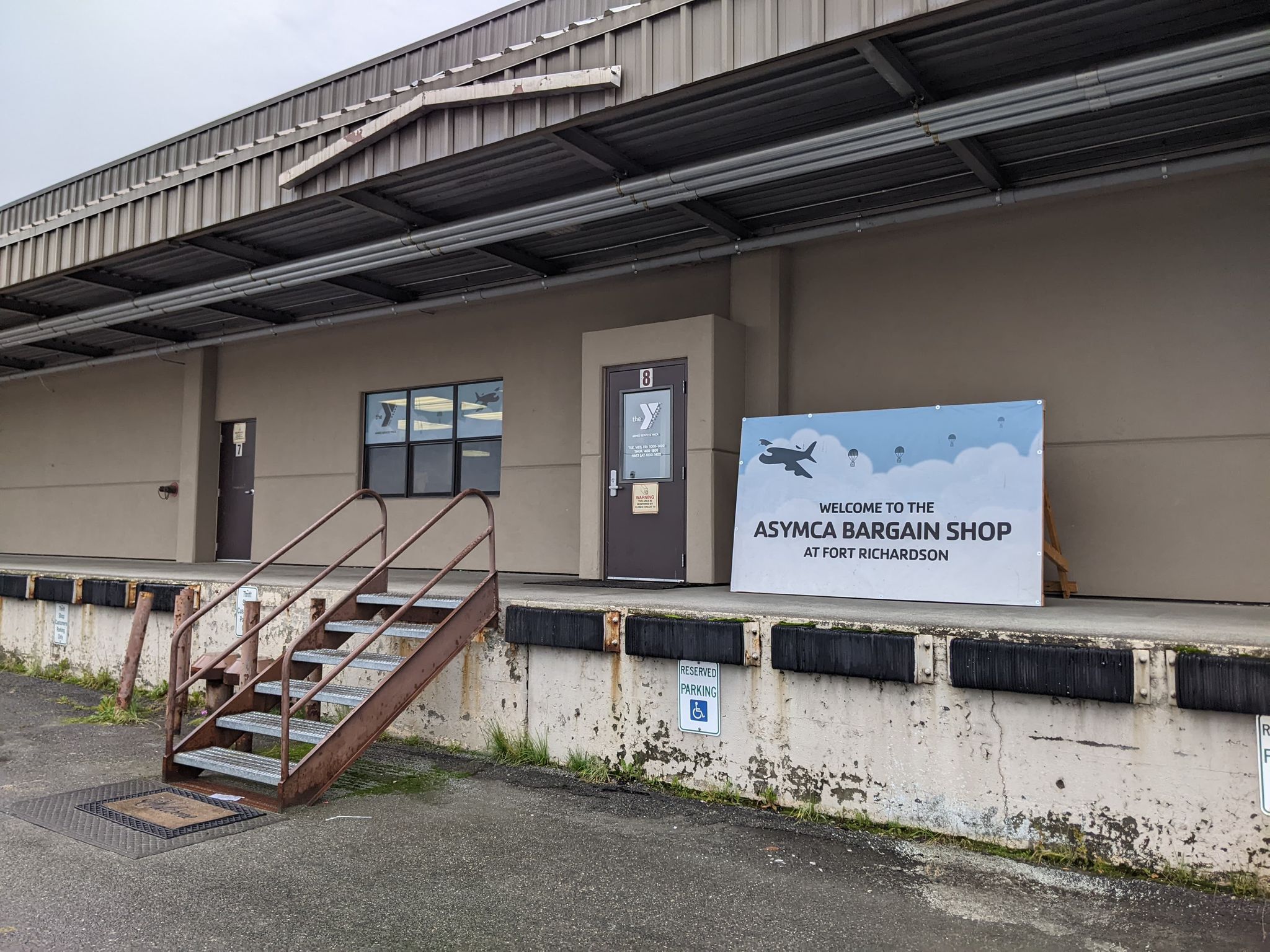 front entrance to asymca bargain shop, tan building with raised entrance