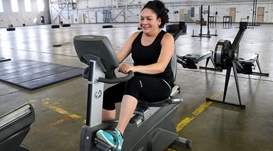 cheerful woman on exercise bike