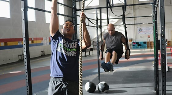 two men engaged in callisthenic workouts