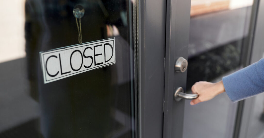 hand trying to open closed door.